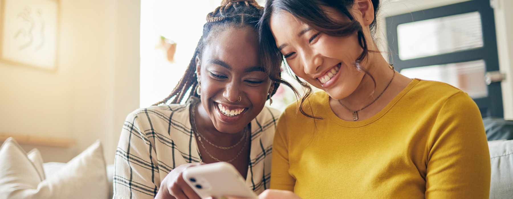 two women looking at a phone