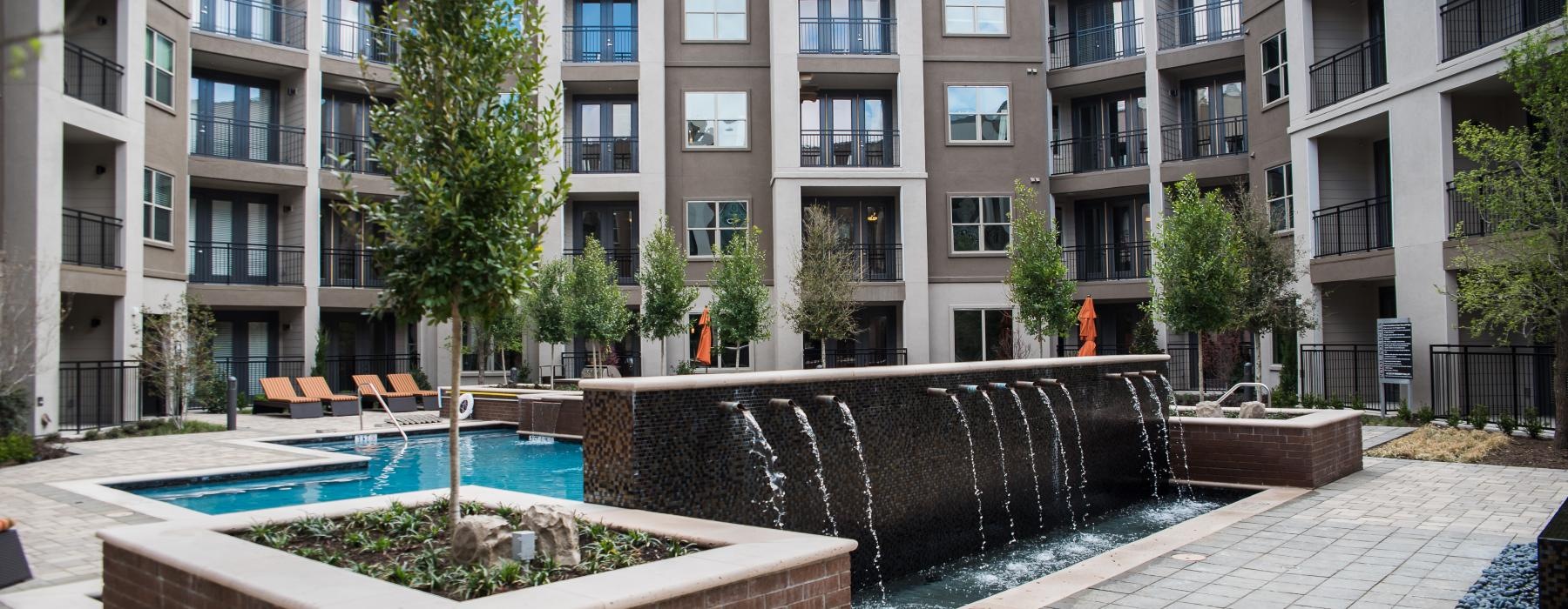 a courtyard with a fountain and buildings