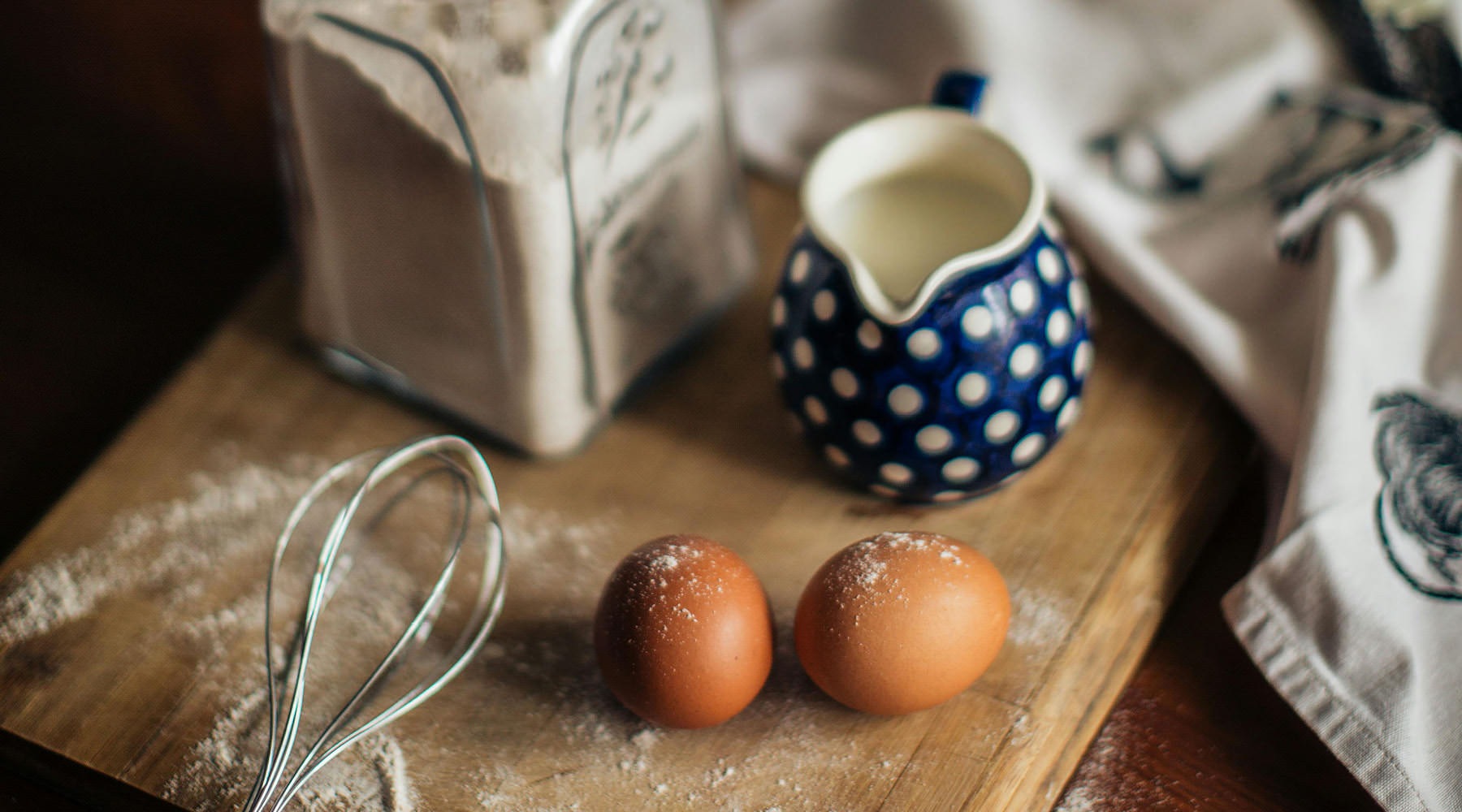 eggs and whisk on a cutting board