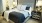a bed with a black and white comforter