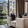 a room with a glass door and a couch and a chair